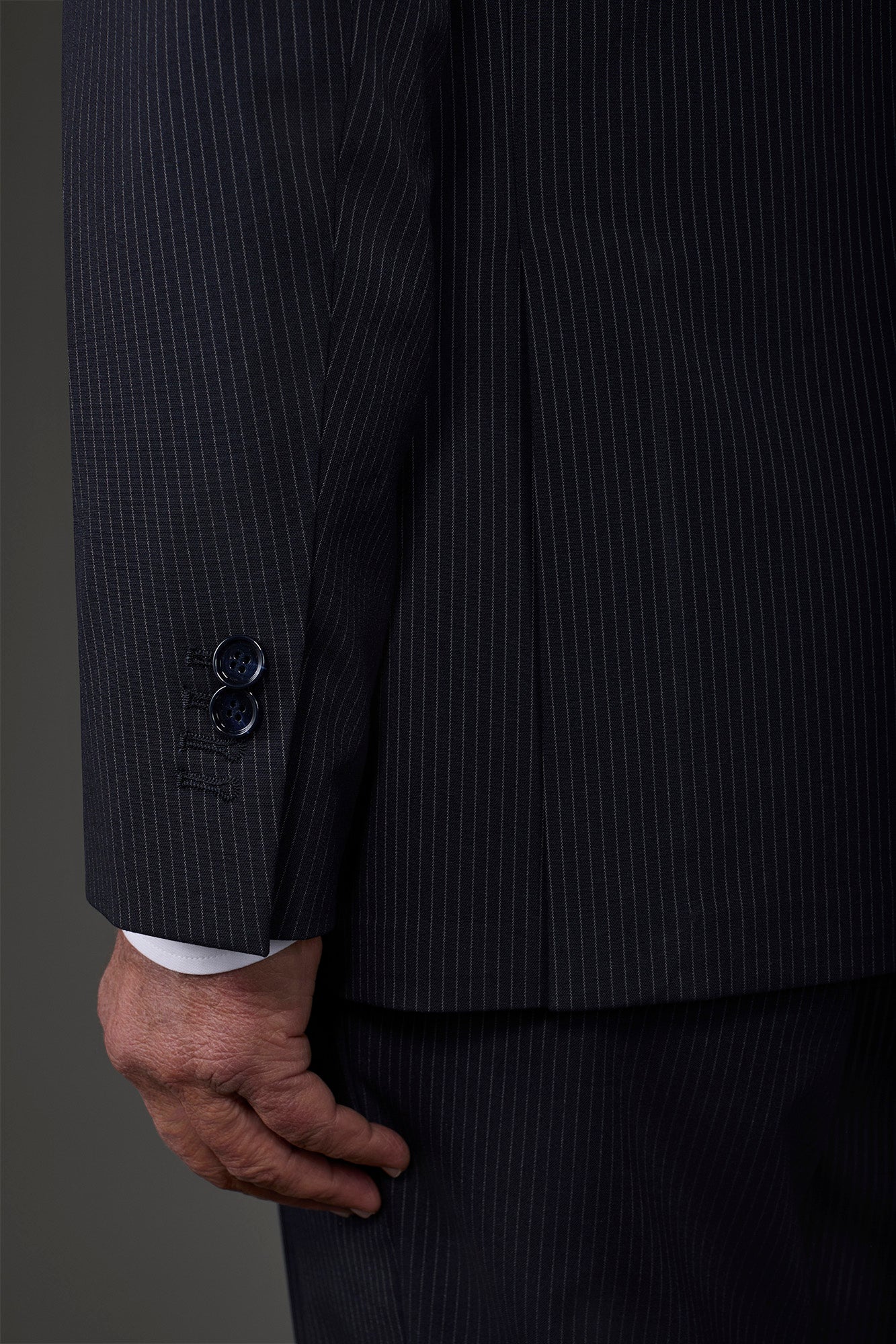 Single-breasted men's suit with flat front trousers in a pinstripe fabric