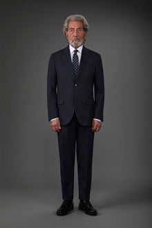 Single-breasted men's suit with flat front trousers in a pinstripe fabric