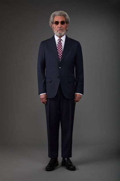 Single-breasted men's suit with classic single-pleat trousers, in pure combed wool with herringbone weave