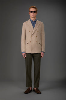 Men's unlined double-breasted jacket with peak lapels and flap pockets. Beige